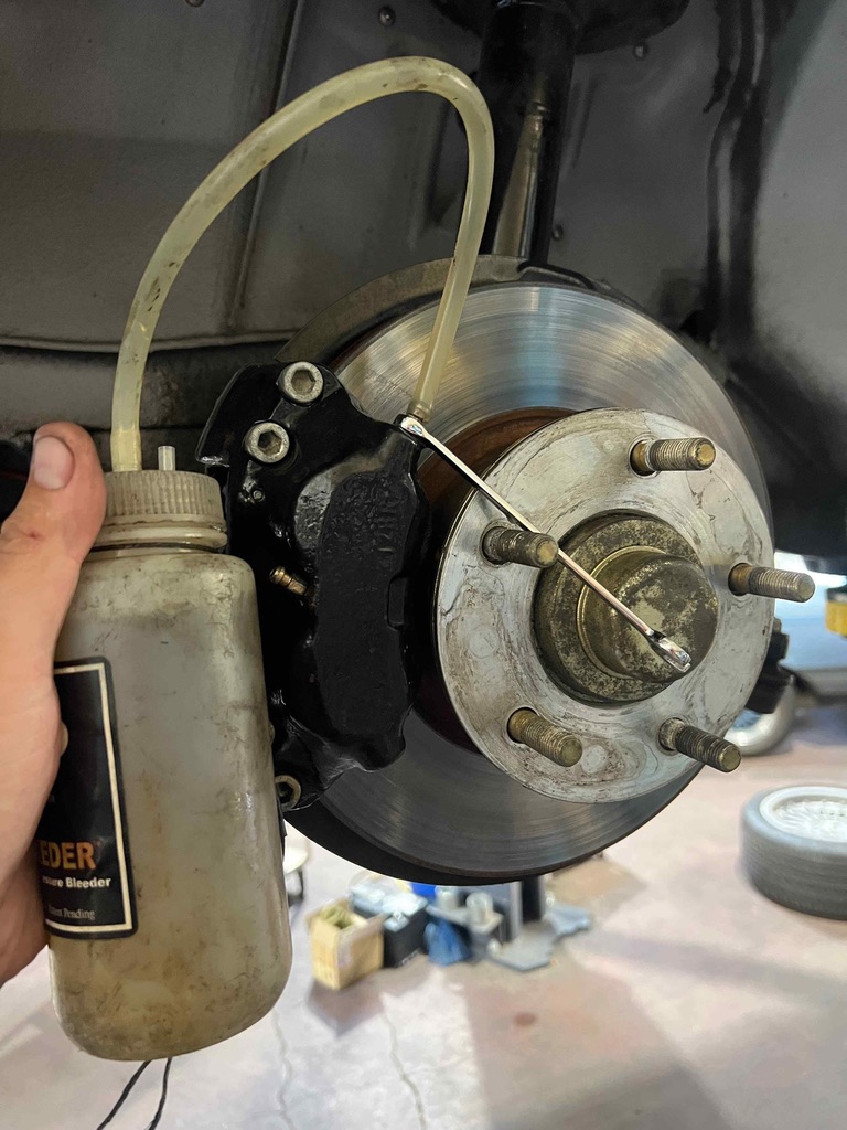 Front brake caliper and rotor, being bled