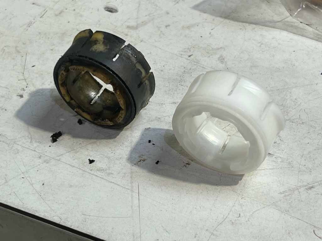 Old, torn bushing next to its replacement